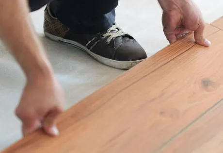 laminate-install-imgs Worker installing laminate | Lions Floor